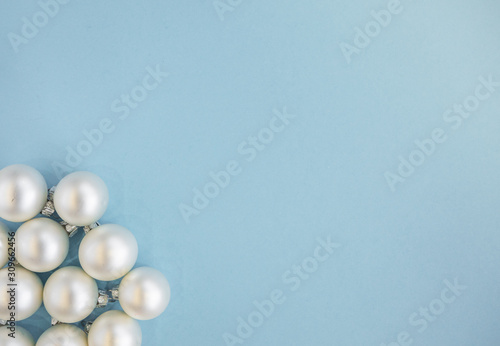Christmas or new year flat lay with white balls on light blue background. Top view  copy space. 