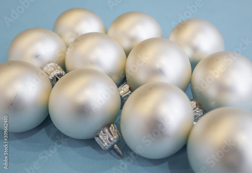 Christmas or new year flat lay with white balls on light blue background. Top view. 