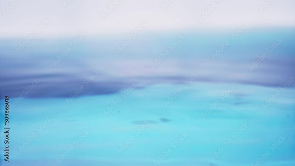 The clean water surface in slow motion fills the screen with water splashing shop the water drop and waving liquid surface with an air bubble. 1080p 29.97fps The clean water surface in slow motion fills the screen with water splashing shop the water drop and waving liquid surface with an air bubble. 1080p 29.97fps