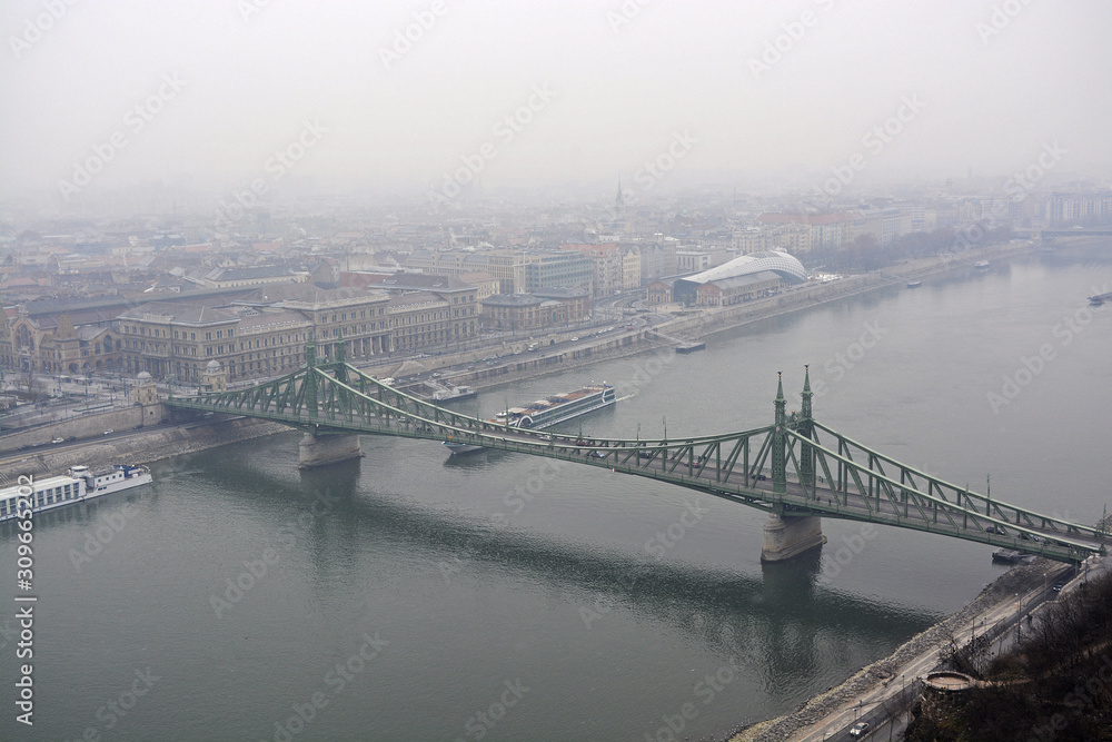 Liberty Bridge or Freedom Bridge in Budapest, Hungary, a foggy and rainy day