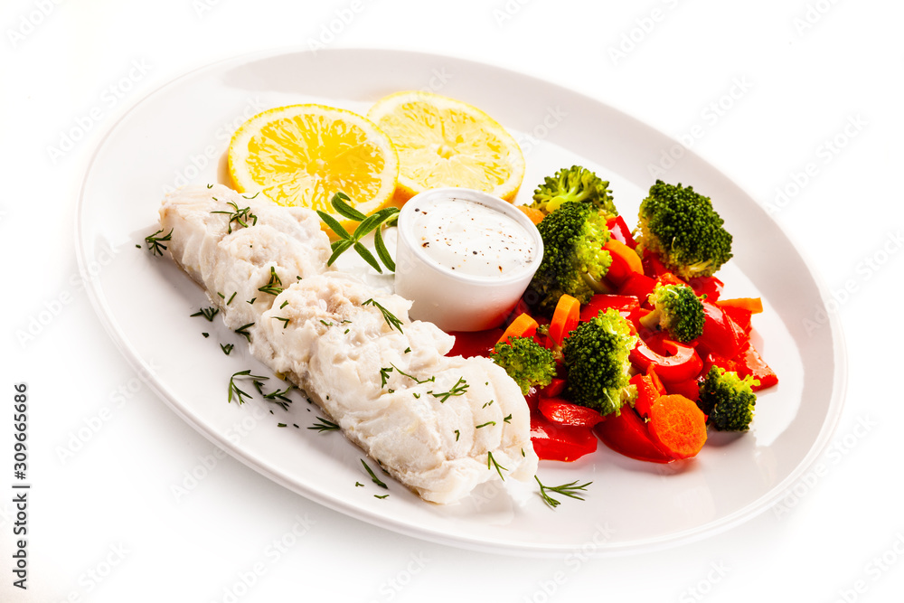 Fish dish - fried fish fillet with vegetables on white background Fish dish - fried fish fillet with vegetables on white background