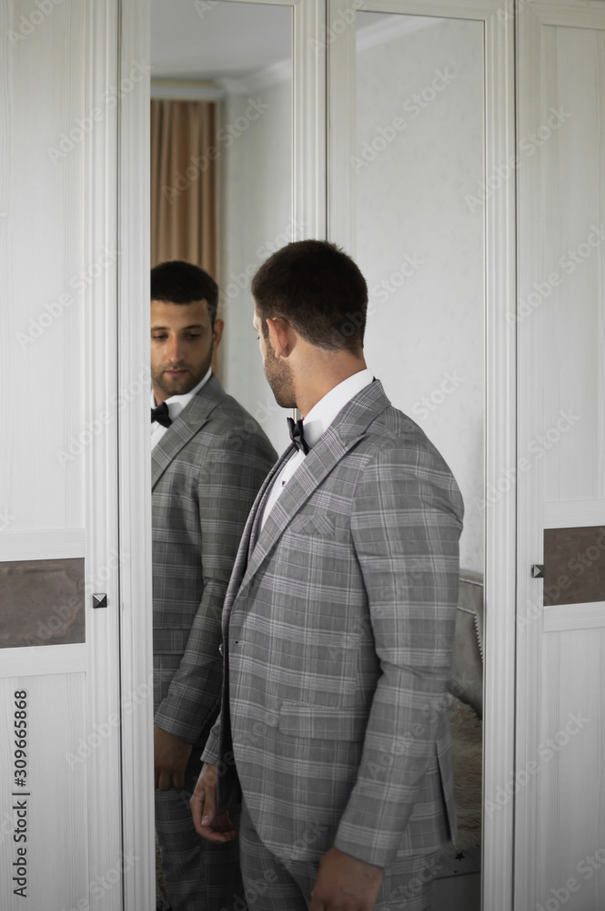 the groom is going to the ceremony on the wedding day. wedding suit. selective focus. film grain. the groom is going to the ceremony on the wedding day. wedding suit. selective focus. film grain.