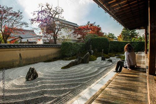 Photography Woman is relaxing in a zen garden in Japan