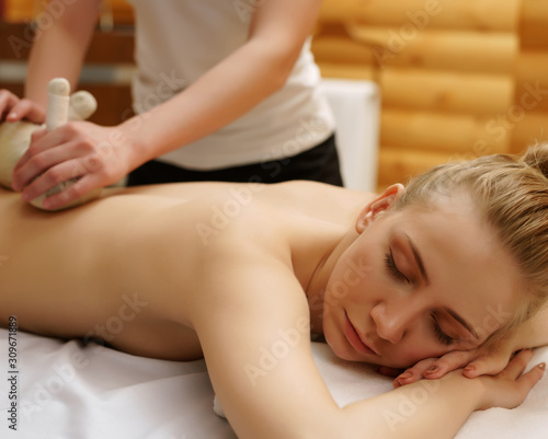 In spa. Girl relaxes during massage with salt bags