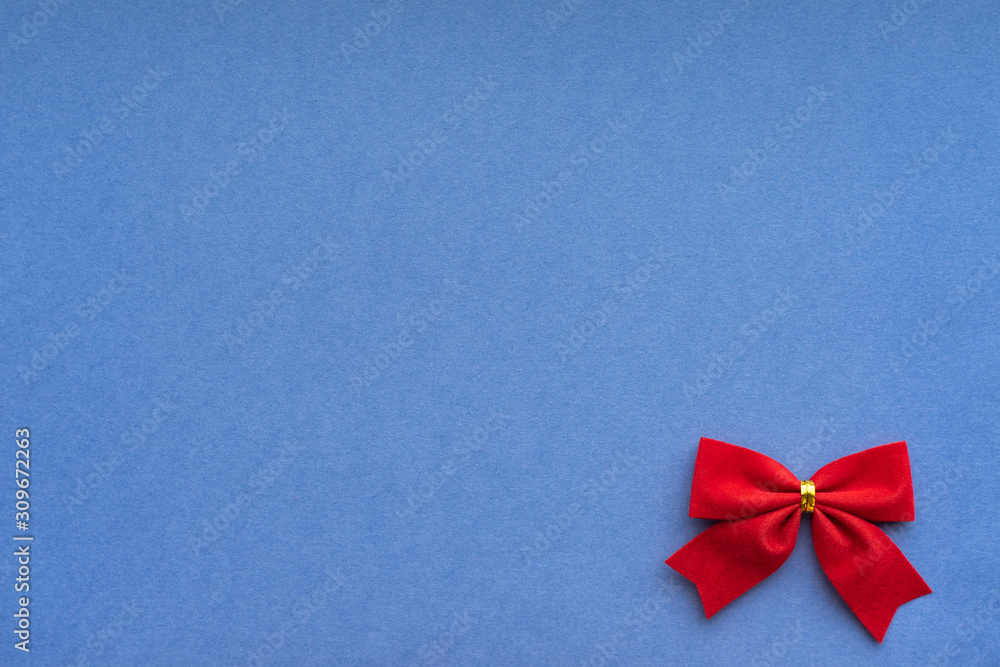 Christmas background with red velvet holiday bows border; blue copy space background