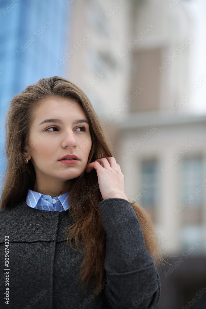 Young adult girl in coat on the street Young adult girl in coat on the street
