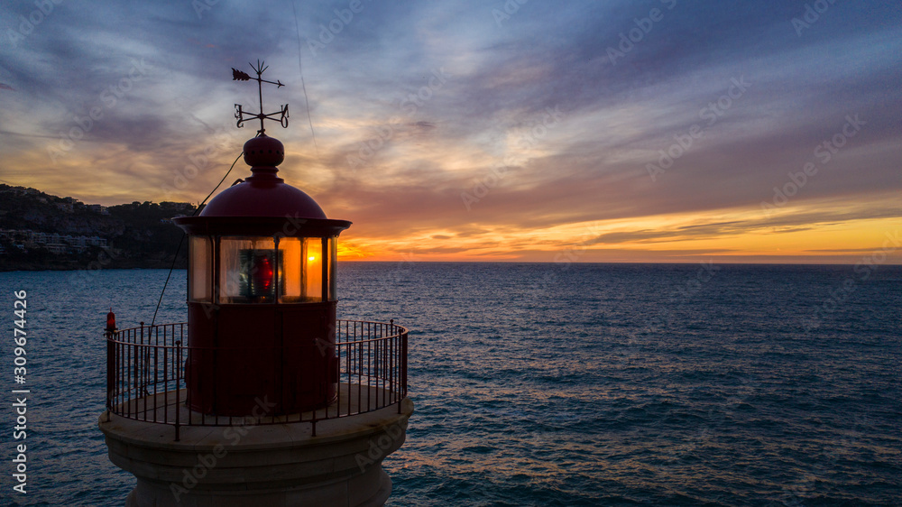 lighthouse at sunset, in the port of Andratx, Majorca Spain