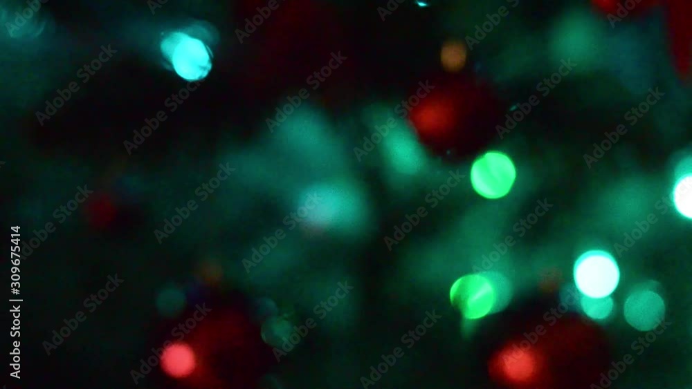 Christmas lights on the tree and decorations. From defocus smoothly into focus. New Year screensaver Christmas lights on the tree and decorations. From defocus smoothly into focus. New Year screensaver