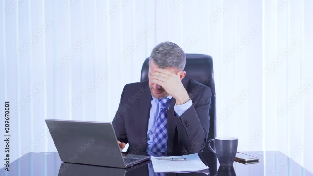Stressful hispanic businessman working with laptop on the table in office room. Shot in 4k resolution Stressful hispanic businessman working with laptop on the table in office room. Shot in 4k resolution