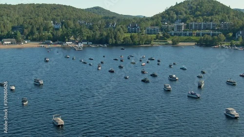 Aerial: flying over a boats on Lake Tremblant in the Laurentian Mountains. Quebec, Canada photo