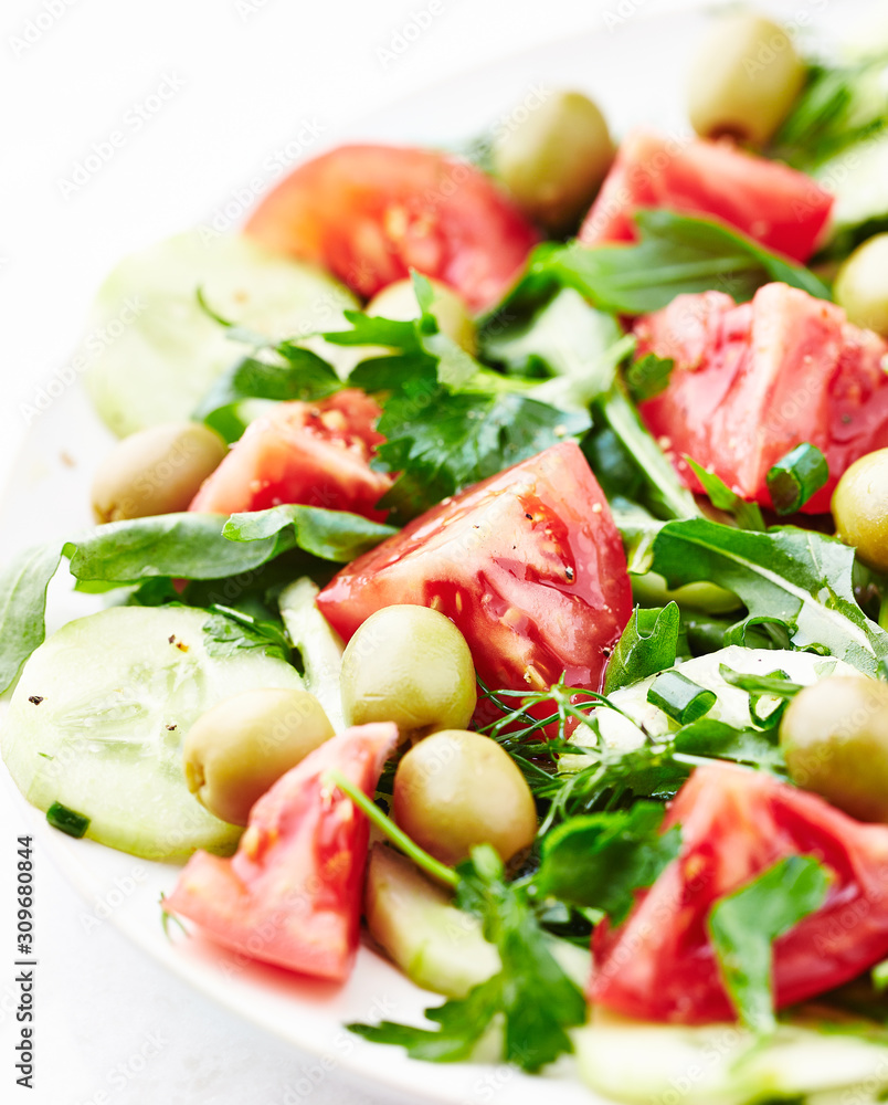 Healthy salad with green olives, tomatoes, cucumber and rocket. Healthy salad with green olives, tomatoes, cucumber and rocket.