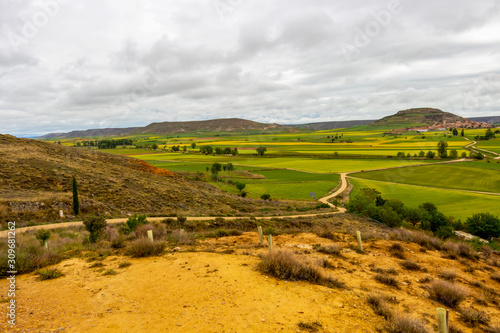 Beautiful landscape on the Way of St. James  Camino de Santiago in Castile and Leon  Spain under overcast May sky  distant view of Castrojeriz in the background