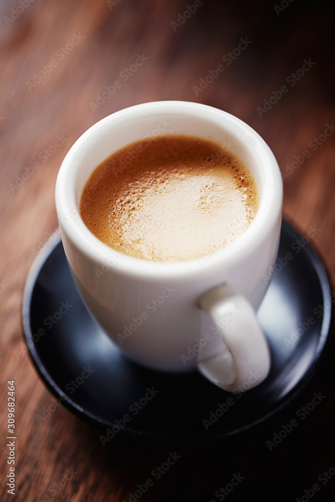 Cup of coffee on brown wooden background. Close up. Cup of coffee on brown wooden background. Close up.