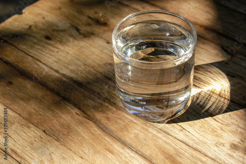 A glass of water and placed on a wooden table
