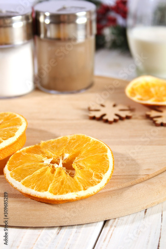 Christmas background with dry oranges and spices.