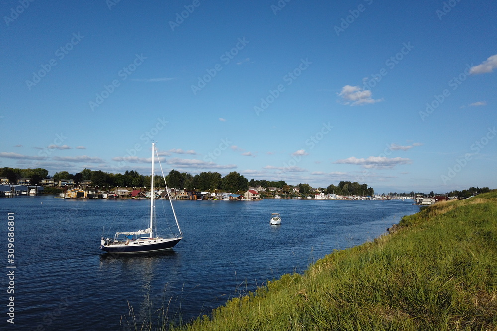 Sailboat and Houseboats on the Columbia River. Hayden Island, Portland, OR Sailboat and Houseboats on the Columbia River. Hayden Island, Portland, OR