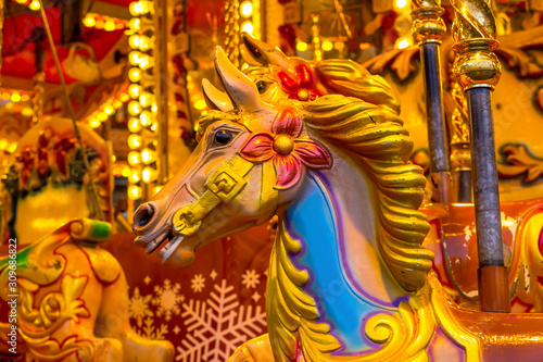 Yellow Vintage merry-go-round wooden horses in carusel
