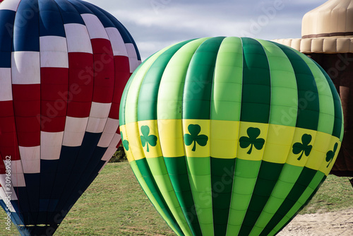 Close up colorful hot air balloons ready to fly in a clear blue sky.