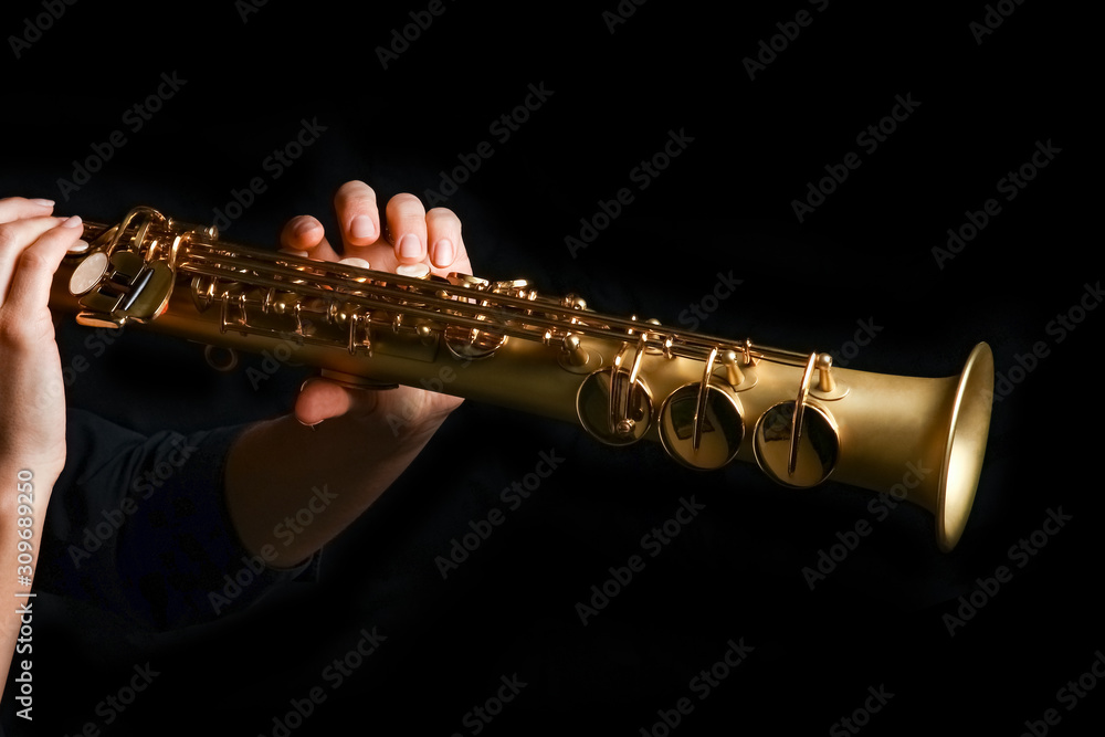 Fototapeta premium soprano saxophone in hands on a black background