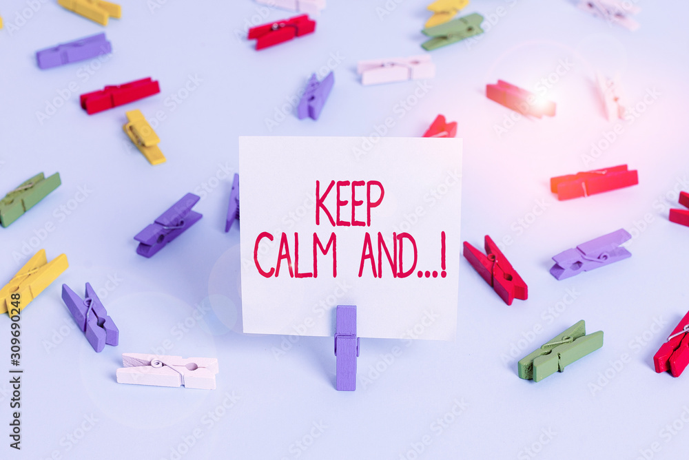 Writing note showing Keep Calm And. Business concept for motivational poster produced by British government Colored clothespin papers empty reminder blue floor officepin Writing note showing Keep Calm And. Business concept for motivational poster produced by British government Colored clothespin papers empty reminder blue floor officepin