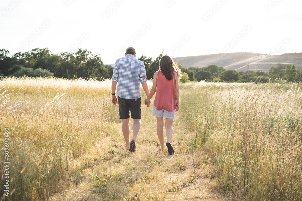 Couple walking in the dry grass