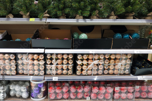 Balls to decorate the Christmas tree. Christmas balls on the counter in plastic containers.