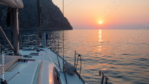 Fototapeta Naklejka Na Ścianę i Meble -  Meet the sunset in the Bay on Board the yacht, a romantic evening at sea. Boat trip on a yacht under sail.