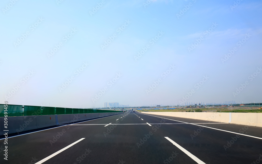 Beautiful highway, under the blue sky and white clouds Beautiful highway, under the blue sky and white clouds