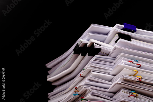 Stack overload document report paper with colorful paperclip.