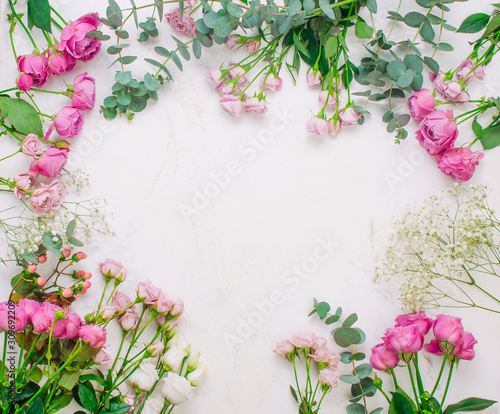 Frame of flowers on white marble background