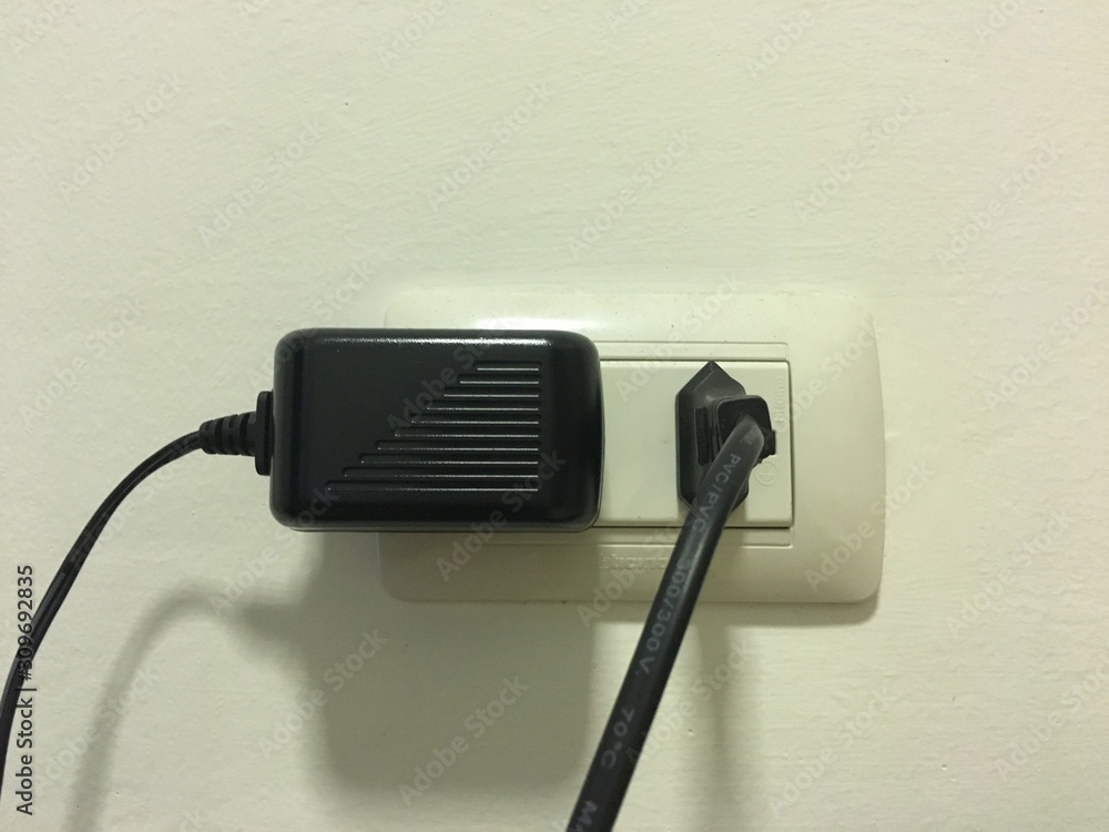 Electricity outlet on the white wall that's covered with safety plugs. Covering plug holes of the surge protector. Safety first concept. Electricity outlet on the white wall that's covered with safety plugs. Covering plug holes of the surge protector. Safety first concept.