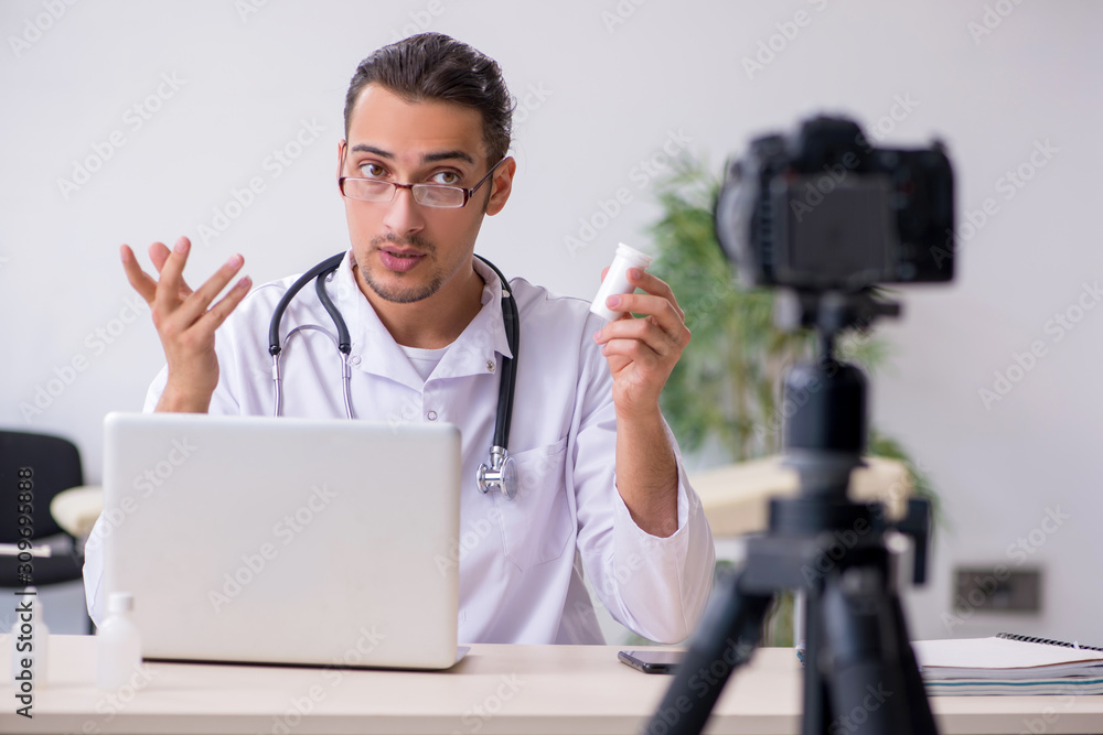 Young male doctor recording video for his blog