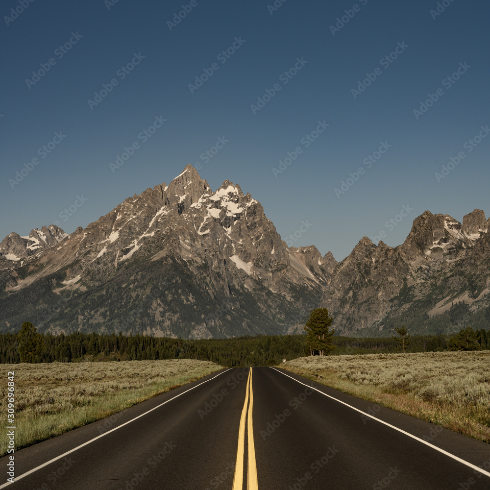 Naklejka premium Fresh Asphalt Runs Below Tetons Range