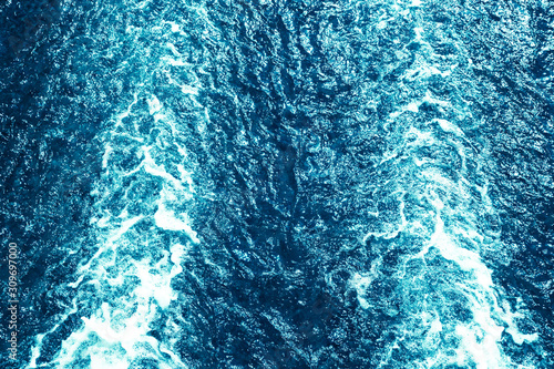 Blue ocean water with ripples and foam texture