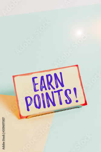 Text sign showing Earn Points. Business photo showcasing collecting scores in order qualify to win big prize Paper placed tilted above buffer wire on soft pastel multi colours backdrop