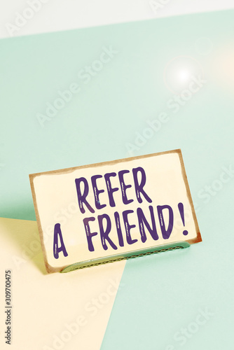 Text sign showing Refer A Friend. Business photo showcasing direct someone to another or send him something like gift Paper placed tilted above buffer wire on soft pastel multi colours backdrop