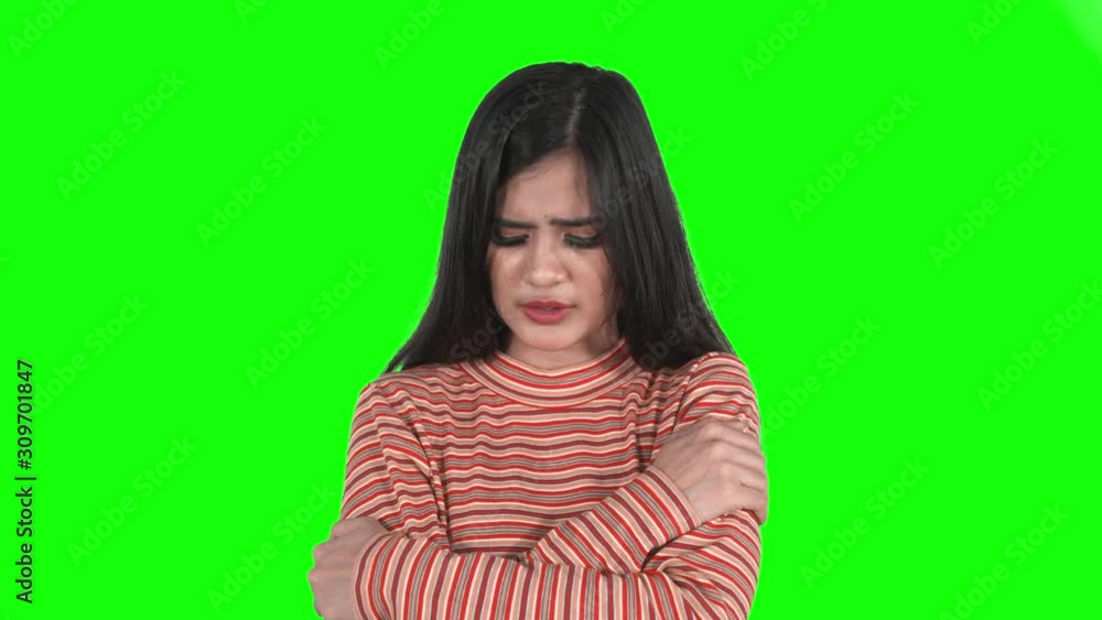 Young woman crying while standing in the studio Young woman crying while standing in the studio