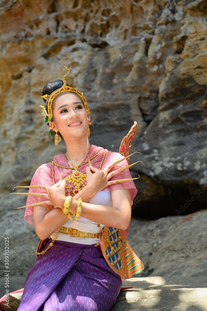 Beautiful Thai girl in traditional dress costume in Kinnaree A fairy tale  animal with a human body, but the tail is a bird, Thai Woman in Traditional  Costume of Thailand. Stock Photo