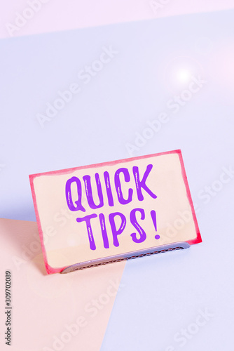 Text sign showing Quick Tips. Business photo showcasing small but particularly useful piece of practical advice Paper placed tilted above buffer wire on soft pastel multi colours backdrop