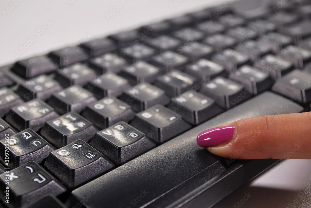 Hands are pressing black keyboard buttons,Scrollbar button on the keyboard.;