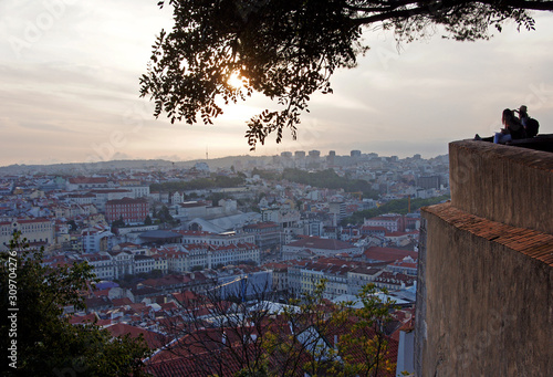 Tourists enjoying the sunset over the Historic City Centre of Lisbon from the top of Saint George Castle (Castelo de São Jorge), Portugal, Europe
