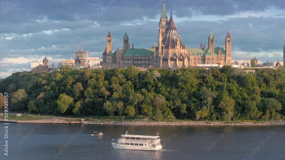 Ferry boat on the Ottawa River. In the background is the Library of Parliament on Parliament Hill. Ottawa, Ontario, Canada. 11 September 2019 Ferry boat on the Ottawa River. In the background is the Library of Parliament on Parliament Hill. Ottawa, Ontario, Canada. 11 September 2019