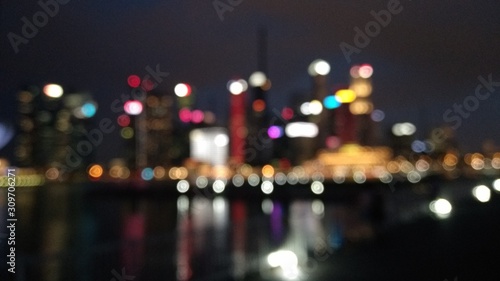Bokeh blurred lights picture of riverside cities at night. © Mungsajati Studio