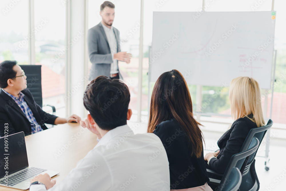 Young businessmen are explaining graphs and statistics on a whiteboard. The managers and employees of the company attending the meeting. Young businessmen are explaining graphs and statistics on a whiteboard. The managers and employees of the company attending the meeting.