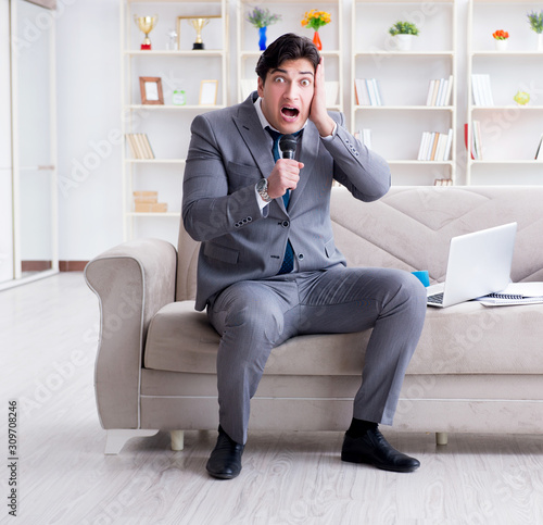 Sad businessman singing in office