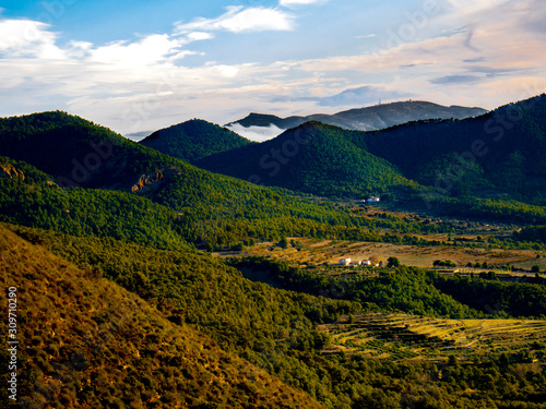 mountainous landscape with greenery and rural houses