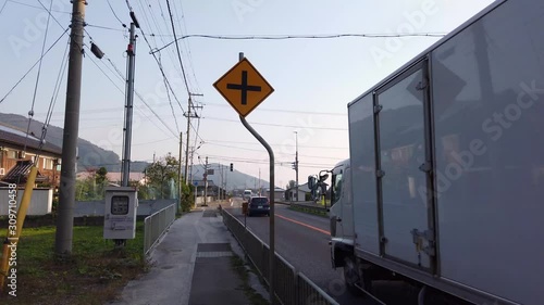 Japanese road in countryside of Shiga Prefecture, cars and trucks traveling past in the afternoon photo