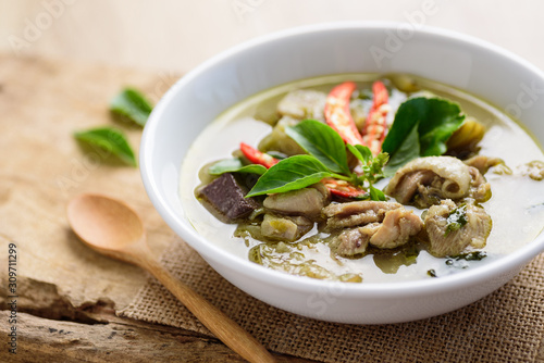 Thai green curry chicken in bowl on wooden background, Thai food