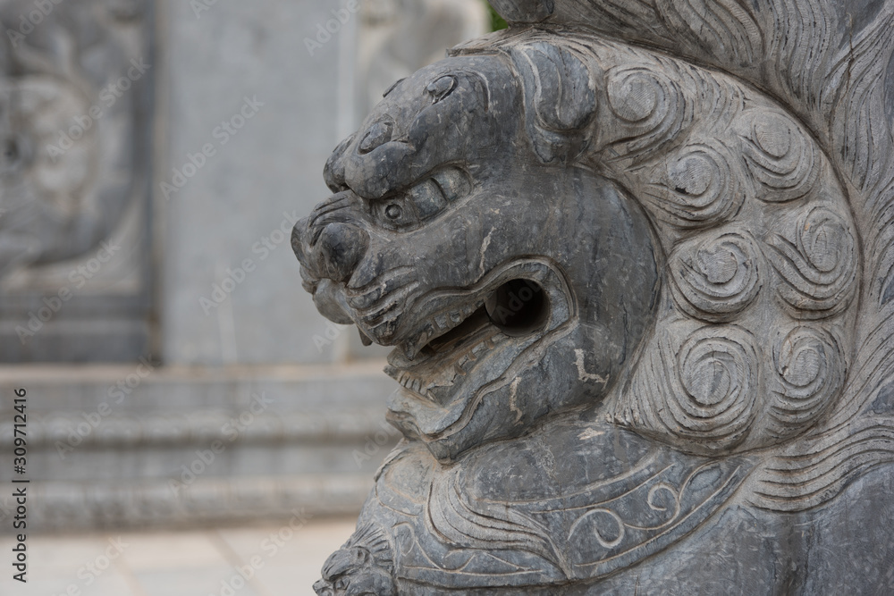 Oriental stone lion closeup on stone pillar Oriental stone lion closeup on stone pillar
