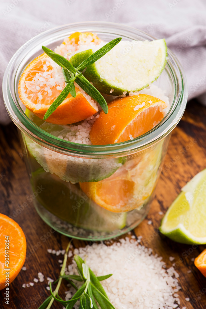 Preserved Lime and Mandarin with salt on a wooden board Preserved Lime and Mandarin with salt on a wooden board